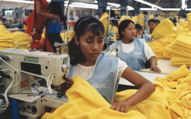 Image: Picture of women and girls working in a sweatshop.