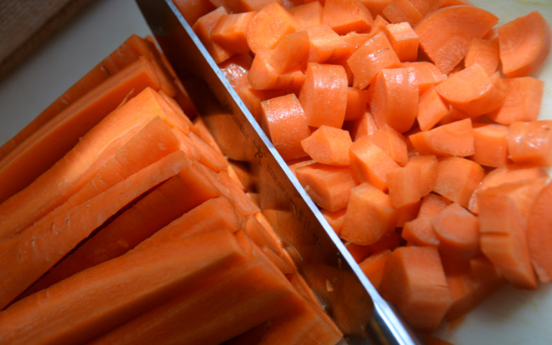 Image: A picture of carrots being chopped.
