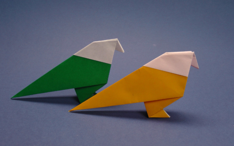 Image: Two origami birds, one yellow and one green.