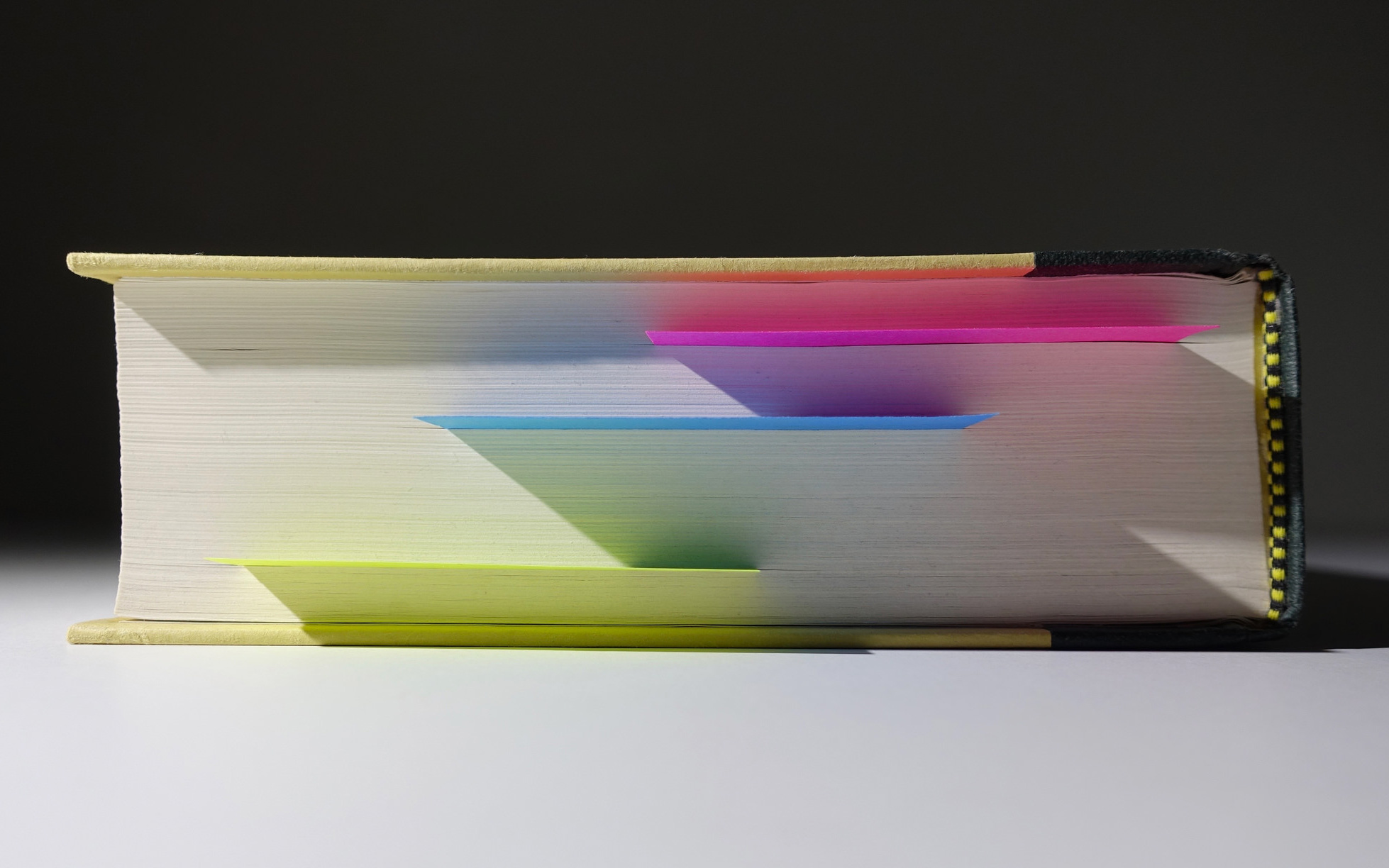 Image: A book with post-it notes marking pages.