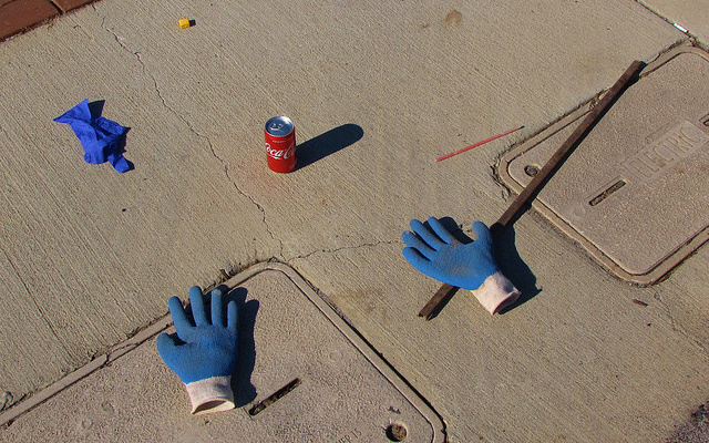 Image: Blue gloves, a stick, and a can of Coke.