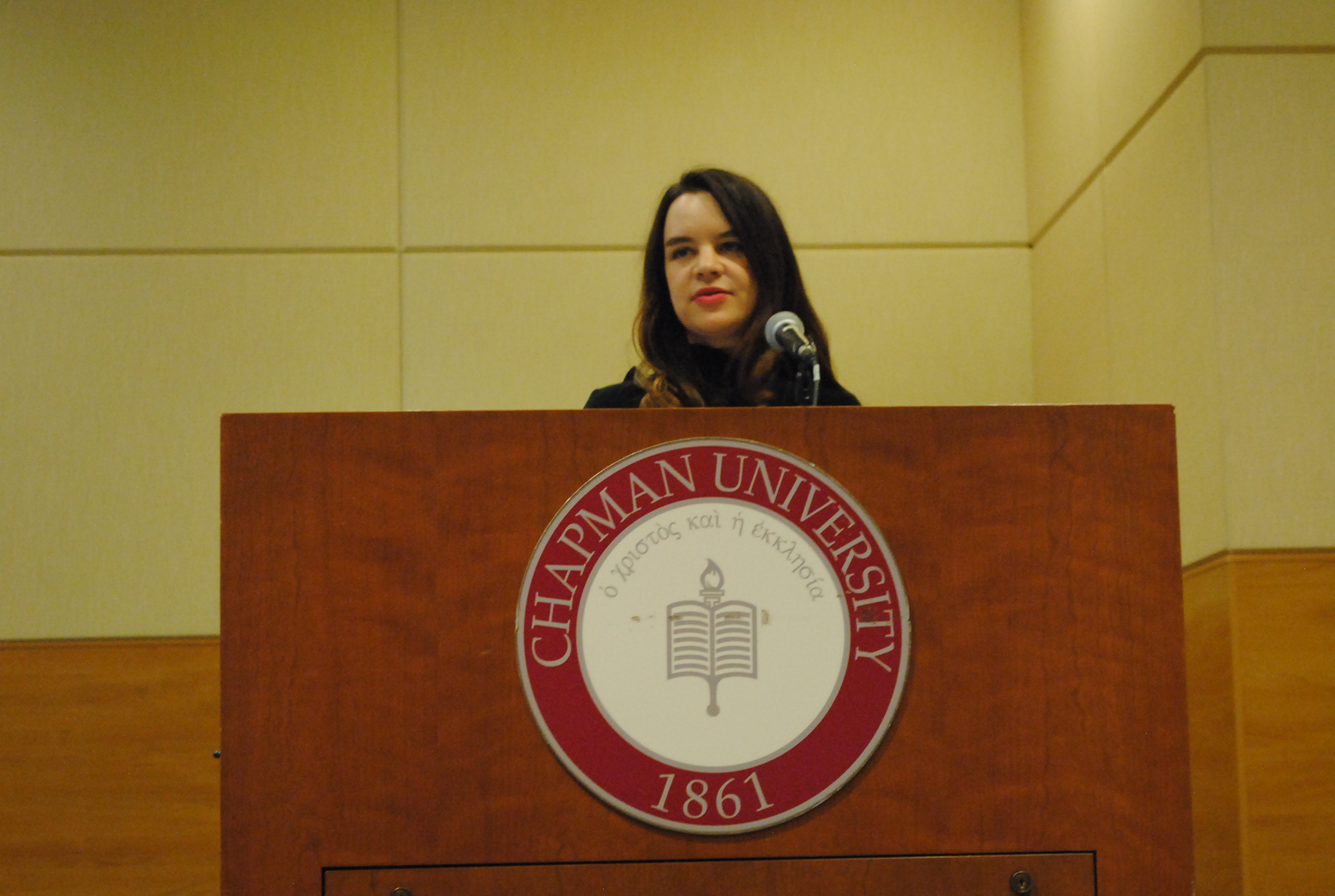 Image: Woman speaking at Chapman University podium.