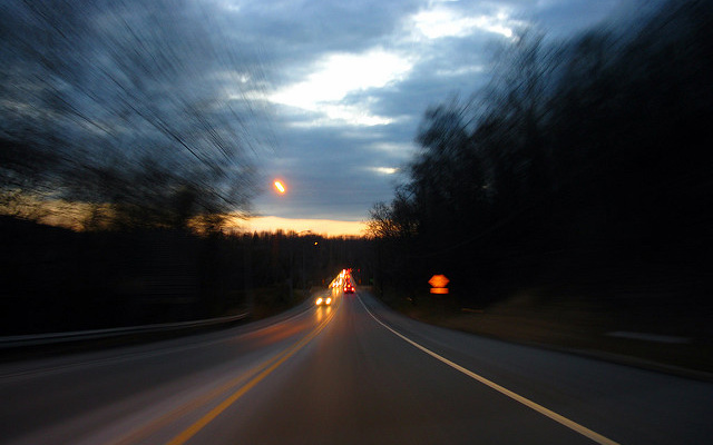 Image: A long road with traffic, blurred.