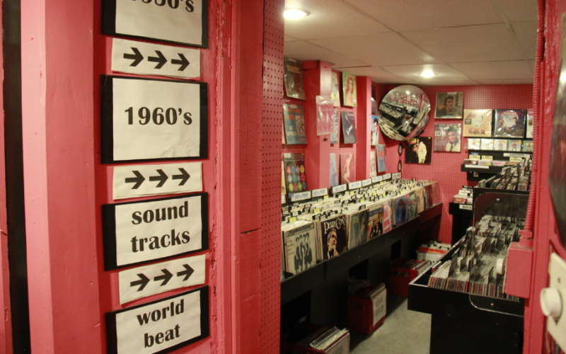 Image: Image of a vintage records store with signs reading "1960s" "Sound tracks" and "World beat"