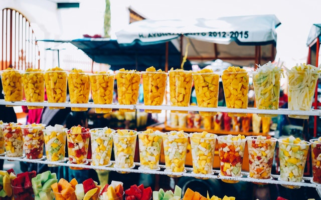 Image: Cut up fruit in cups lined up at a market, Photo by Ricardo Esquivel from Pexels