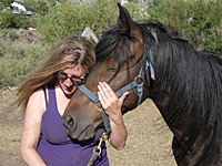 Author Stillman holding rescued horse Bugz